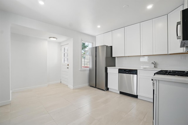 419 S 7th Ave, Mount Vernon, NY 10550 - kitchen with appliances with stainless steel finishes, light countertops, white cabinetry, baseboards, and recessed lighting
