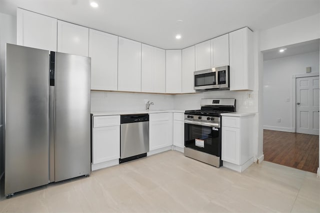 419 S 7th Ave, Mount Vernon, NY 10550 - kitchen featuring appliances with stainless steel finishes, light countertops, decorative backsplash, recessed lighting, and white cabinets