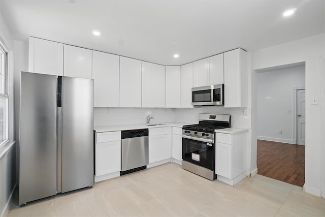 419 S 7th Ave, Mount Vernon, NY 10550 - kitchen with stainless steel appliances, light countertops, white cabinets, and recessed lighting