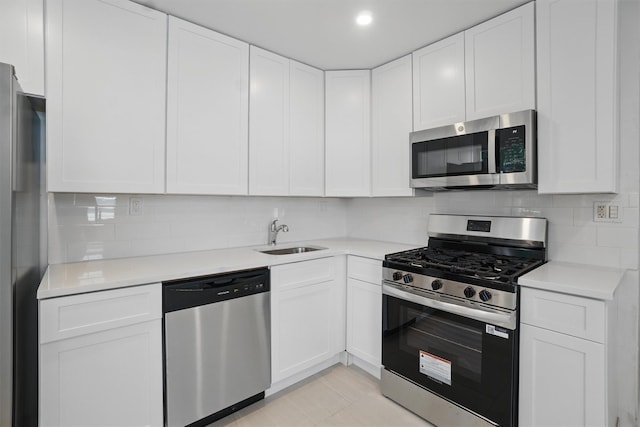 419 S 7th Ave, Mount Vernon, NY 10550 - kitchen featuring appliances with stainless steel finishes, a sink, white cabinets, and light countertops