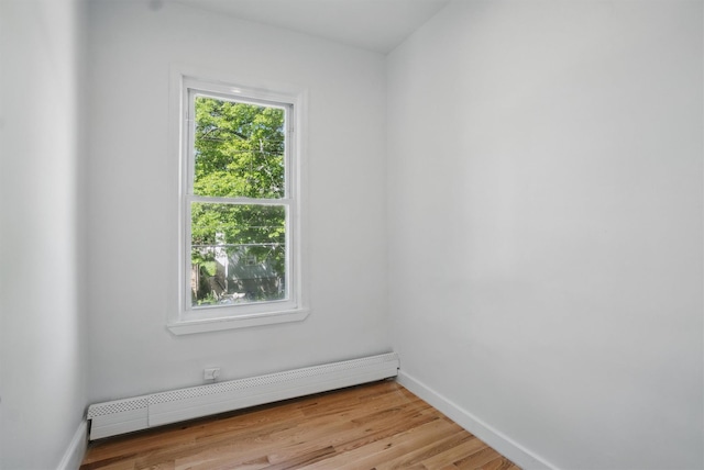419 S 7th Ave, Mount Vernon, NY 10550 - empty room with a baseboard heating unit, baseboards, and light wood-style flooring