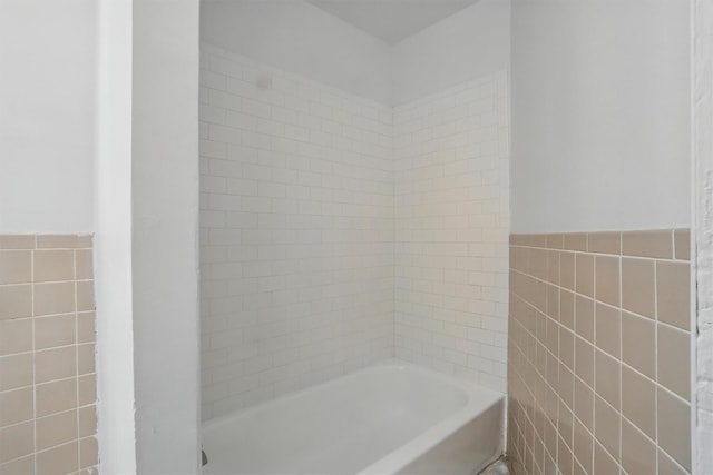 419 S 7th Ave, Mount Vernon, NY 10550 - bathroom featuring tile walls, a bath, wainscoting, and a shower