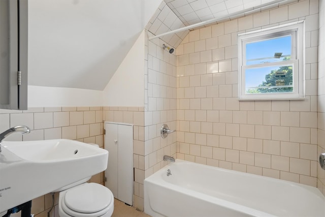 419 S 7th Ave, Mount Vernon, NY 10550 - full bath with tile walls, washtub / shower combination, vaulted ceiling, a sink, and toilet