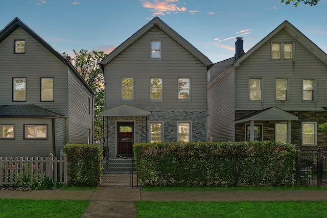 419 S 7th Ave, Mount Vernon, NY 10550 - traditional home featuring stone siding, a fenced front yard, and a gate