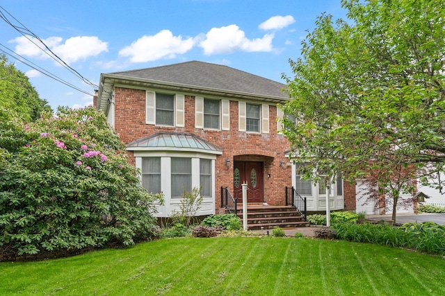 14 Battle Row, Old Bethpage, NY 11804 - view of front of property featuring brick siding, a front yard, and a shingled roof
