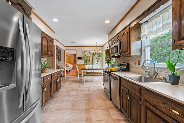 14 Battle Row, Old Bethpage, NY 11804 - kitchen featuring stainless steel appliances, a sink, light countertops, backsplash, and hanging light fixtures