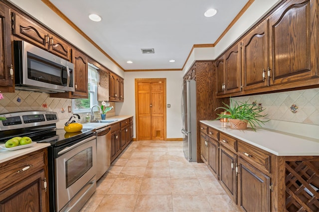 14 Battle Row, Old Bethpage, NY 11804 - kitchen featuring stainless steel appliances, light countertops, ornamental molding, backsplash, and a sink