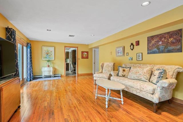 14 Battle Row, Old Bethpage, NY 11804 - living room featuring light wood-style floors, a baseboard heating unit, recessed lighting, and baseboards