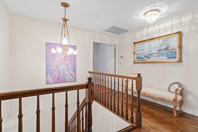 14 Battle Row, Old Bethpage, NY 11804 - stairway with a chandelier, wood finished floors, and baseboards