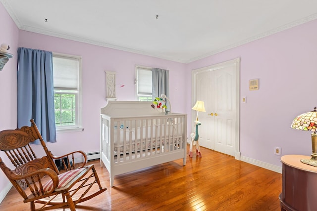 14 Battle Row, Old Bethpage, NY 11804 - bedroom featuring wood finished floors, crown molding, and baseboards
