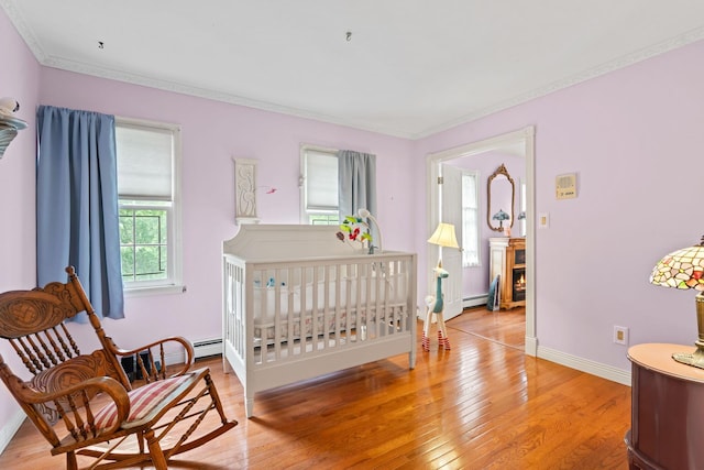 14 Battle Row, Old Bethpage, NY 11804 - bedroom featuring light wood-type flooring, ornamental molding, a baseboard radiator, and baseboards