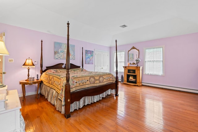 14 Battle Row, Old Bethpage, NY 11804 - bedroom with light wood-style flooring, a baseboard heating unit, and a closet