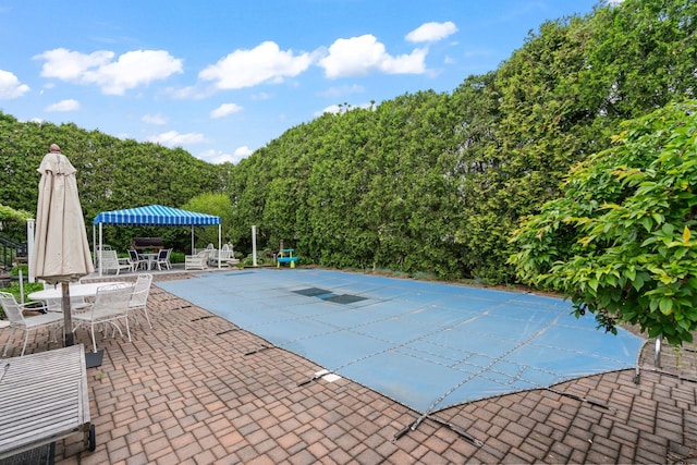 14 Battle Row, Old Bethpage, NY 11804 - view of swimming pool with outdoor dining space, a patio area, and a covered pool