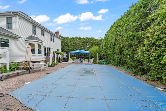 14 Battle Row, Old Bethpage, NY 11804 - view of swimming pool with a patio area, outdoor dining space, and a covered pool
