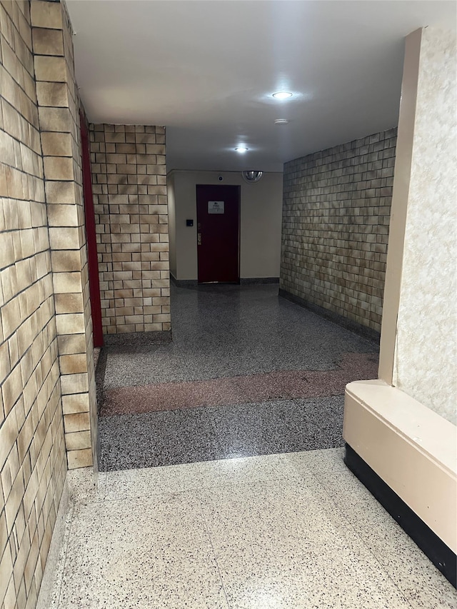 610 Waring Ave Unit 6C, Bronx, NY 10467 - hallway with speckle patterned floor and brick wall