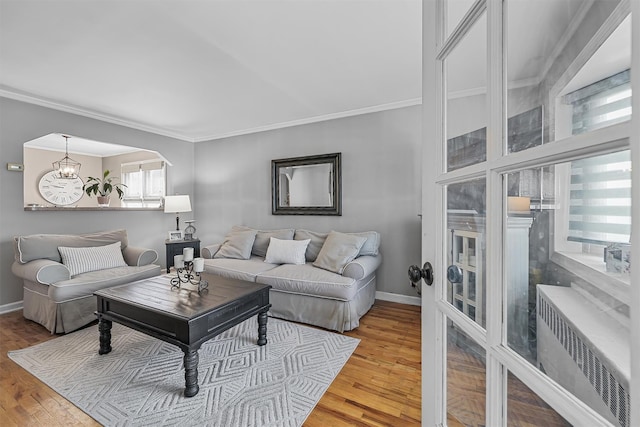 2808 Philip Ave, Bronx, NY 10465 - living area featuring crown molding, wood finished floors, baseboards, and a chandelier