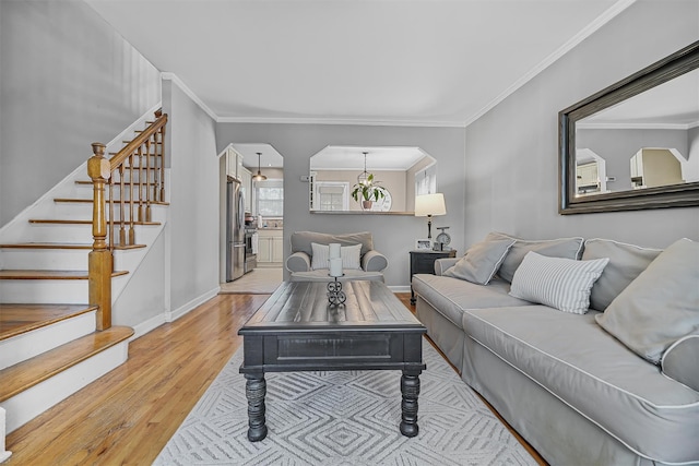 2808 Philip Ave, Bronx, NY 10465 - living room featuring wood finished floors, stairway, arched walkways, ornamental molding, and baseboards