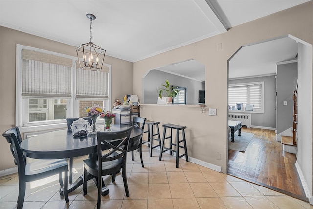 2808 Philip Ave, Bronx, NY 10465 - dining space featuring radiator heating unit, a chandelier, crown molding, baseboards, and light tile patterned flooring
