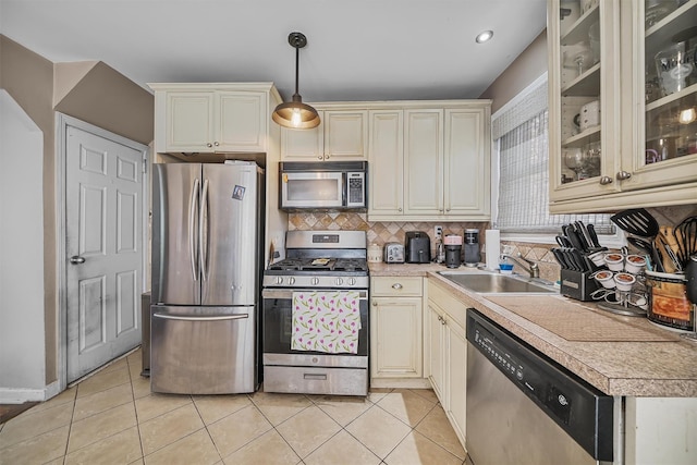 2808 Philip Ave, Bronx, NY 10465 - kitchen with stainless steel appliances, cream cabinetry, a sink, light countertops, and decorative backsplash