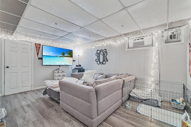 2808 Philip Ave, Bronx, NY 10465 - living area featuring wood finished floors, a paneled ceiling, and a wall mounted AC