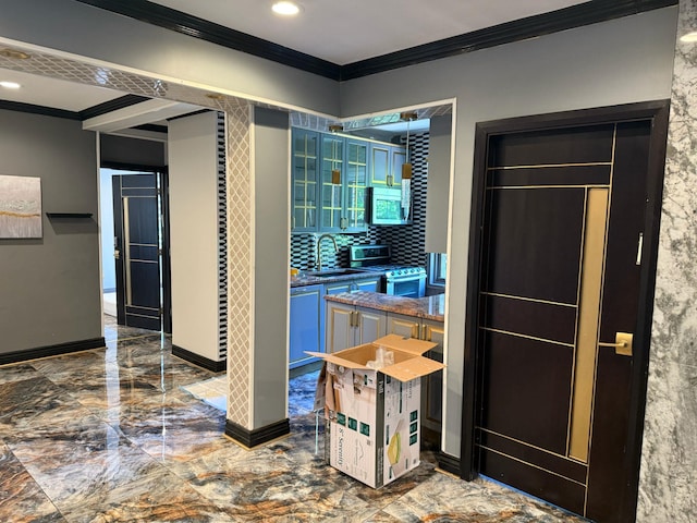 255 Central Ave Unit 202-A, Lawrence, NY 11559 - bathroom featuring crown molding, a sink, marble tiled flooring, decorative backsplash, and baseboards