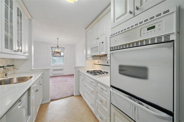 600 Locust St Unit 7C, Mount Vernon, NY 10552 - kitchen featuring a sink, radiator, white appliances, a warming drawer, and light countertops