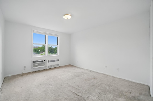 600 Locust St Unit 7C, Mount Vernon, NY 10552 - carpeted spare room with radiator, an AC wall unit, and baseboards