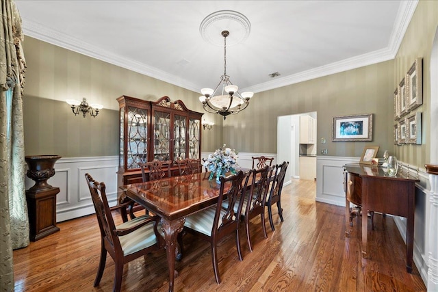 40 Carlisle Ln, East Islip, NY 11730 - dining room with a chandelier, wood finished floors, a wainscoted wall, a decorative wall, and ornamental molding