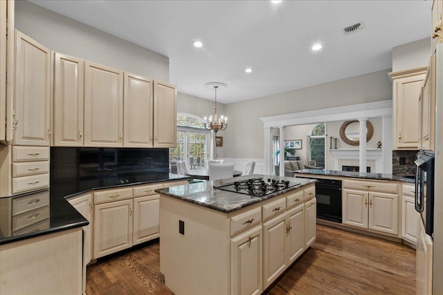 40 Carlisle Ln, East Islip, NY 11730 - kitchen with a center island, a chandelier, decorative backsplash, dark wood-style floors, and wainscoting