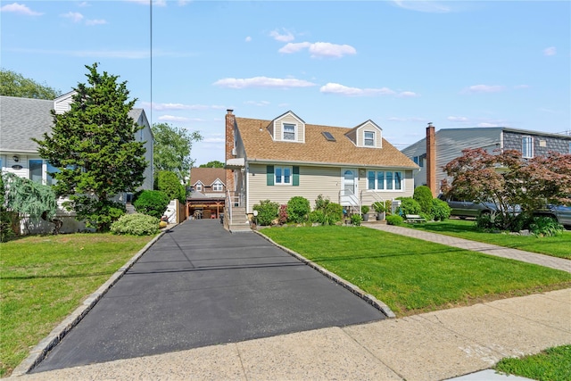 64 Chester Rd, Lynbrook, NY 11563 - view of front of property featuring a front yard, a shingled roof, and a chimney
