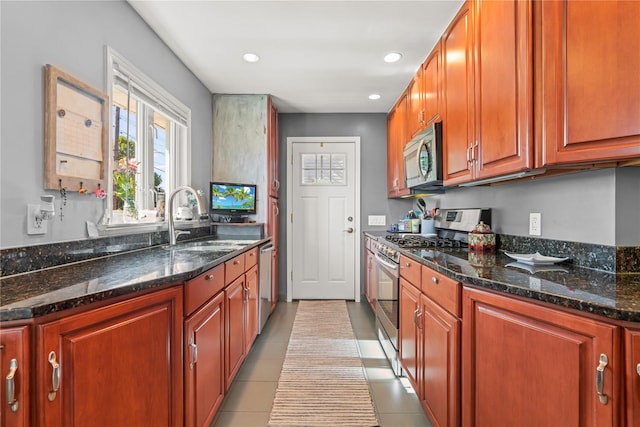 64 Chester Rd, Lynbrook, NY 11563 - kitchen with stainless steel appliances, a sink, dark stone counters, recessed lighting, and light tile patterned floors