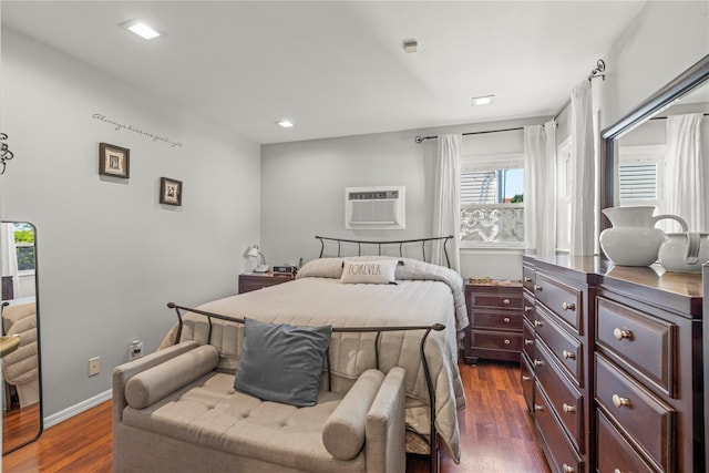 64 Chester Rd, Lynbrook, NY 11563 - bedroom with dark wood finished floors, a wall mounted AC, and baseboards