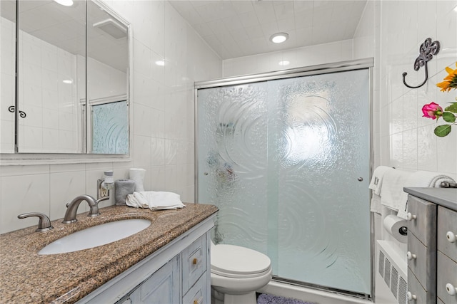 64 Chester Rd, Lynbrook, NY 11563 - bathroom featuring tile walls, vanity, a stall shower, and toilet