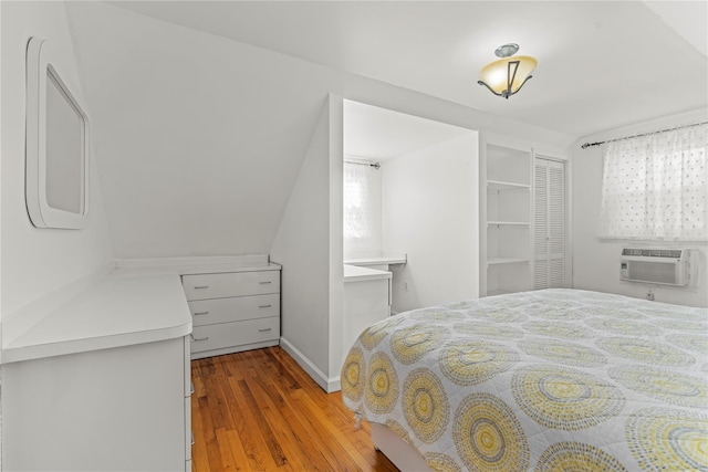 64 Chester Rd, Lynbrook, NY 11563 - bedroom with a wall mounted AC, wood finished floors, baseboards, and multiple windows