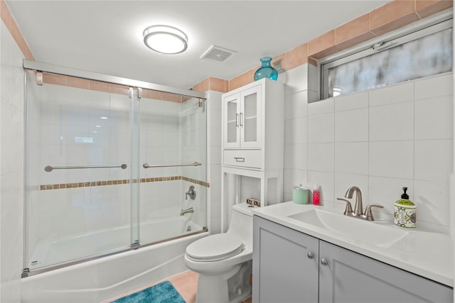 64 Chester Rd, Lynbrook, NY 11563 - full bath featuring tile walls, combined bath / shower with glass door, toilet, and vanity