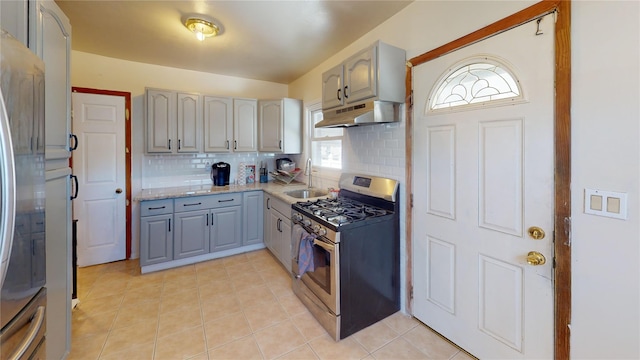 386 Locust Ave, Uniondale, NY 11553 - kitchen featuring stainless steel appliances, under cabinet range hood, a sink, gray cabinetry, and decorative backsplash