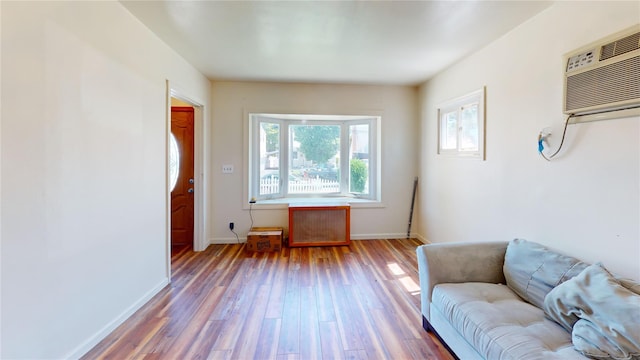 386 Locust Ave, Uniondale, NY 11553 - sitting room with wood finished floors, baseboards, and a wall mounted AC