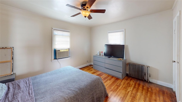 386 Locust Ave, Uniondale, NY 11553 - bedroom with radiator heating unit, light wood-type flooring, cooling unit, baseboards, and crown molding