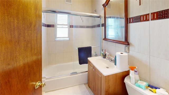386 Locust Ave, Uniondale, NY 11553 - bathroom with tile walls, vanity, and enclosed tub / shower combo