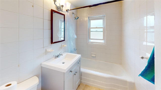 386 Locust Ave, Uniondale, NY 11553 - full bathroom with tile walls, toilet, washtub / shower combination, and vanity