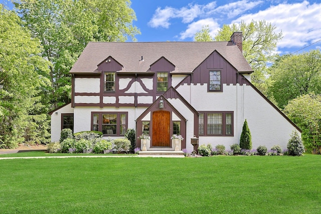 106 Garden Rd, Scarsdale, NY 10583 - english style home featuring a chimney, a front lawn, and roof with shingles