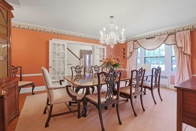 106 Garden Rd, Scarsdale, NY 10583 - dining area featuring a chandelier, radiator, and baseboards
