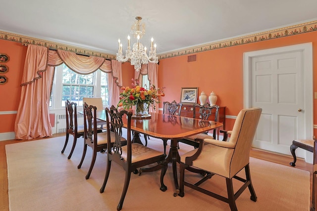 106 Garden Rd, Scarsdale, NY 10583 - dining area with a chandelier, light wood-style floors, and baseboards