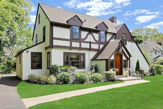 106 Garden Rd, Scarsdale, NY 10583 - rear view of house with a lawn, a chimney, stucco siding, and roof with shingles