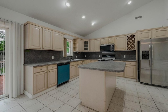 5 Charles St, Selden, NY 11784 - kitchen with appliances with stainless steel finishes, light brown cabinetry, decorative backsplash, lofted ceiling, and a sink