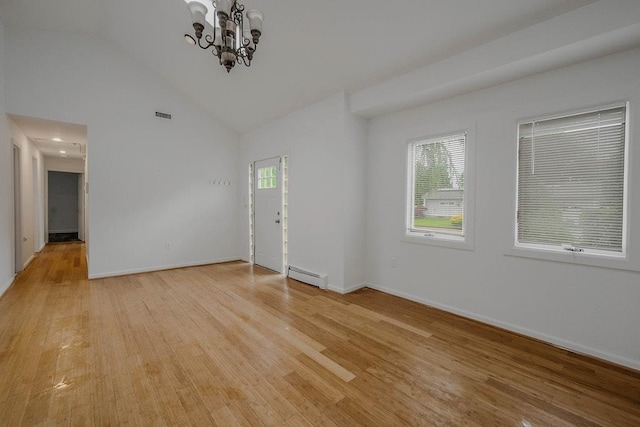 5 Charles St, Selden, NY 11784 - unfurnished living room with a baseboard heating unit, light wood-style floors, a chandelier, baseboards, and high vaulted ceiling