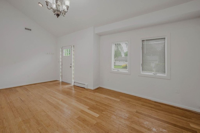 5 Charles St, Selden, NY 11784 - unfurnished room featuring a baseboard radiator, a chandelier, light wood-style flooring, vaulted ceiling, and baseboards