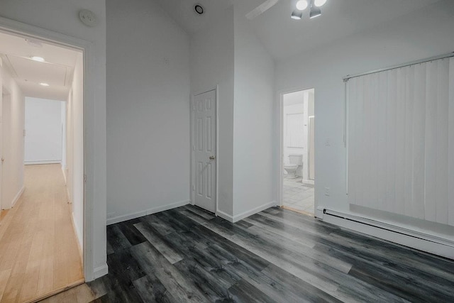 5 Charles St, Selden, NY 11784 - unfurnished bedroom with a baseboard heating unit, wood finished floors, ensuite bathroom, high vaulted ceiling, and baseboards