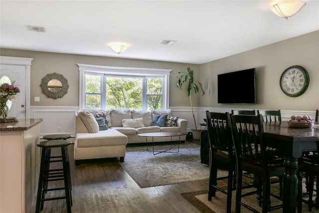 110 Sound Beach Blvd, Sound Beach, NY 11789 - living room featuring a wainscoted wall, dark wood-style flooring, and a decorative wall