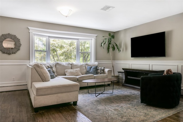 110 Sound Beach Blvd, Sound Beach, NY 11789 - living room with a baseboard radiator, a decorative wall, wainscoting, and wood finished floors